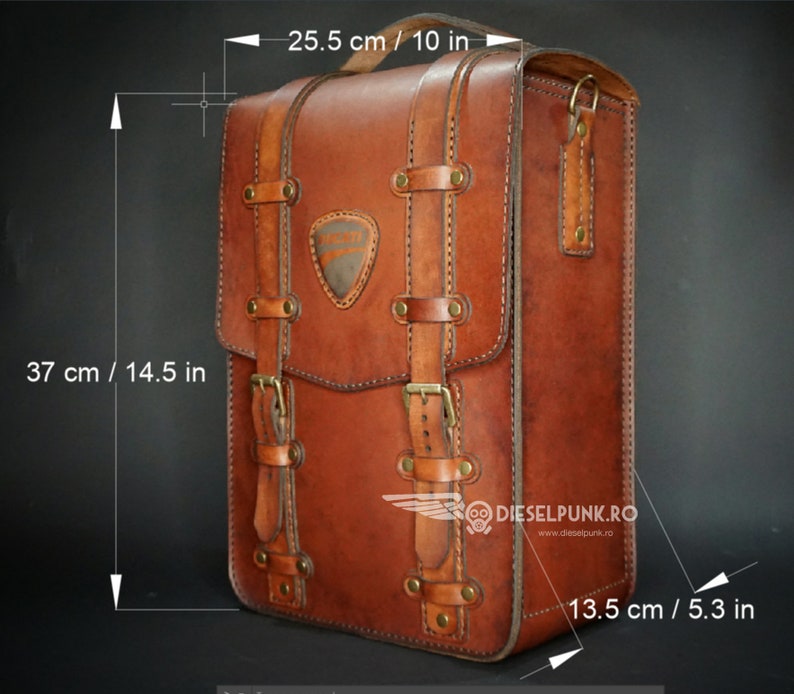 May include: A brown leather backpack with a buckle closure and a stitched design. The backpack measures 14.5 inches tall, 10 inches wide, and 5.3 inches deep. The bag has a logo on the front that says "DIESELPUNK.RO" and "www.dieselpunk.ro".