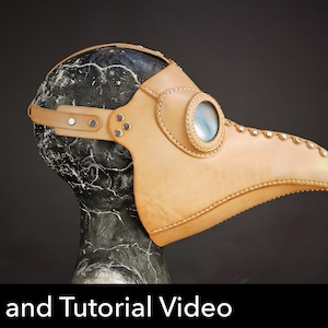 May include: A tan leather plague doctor mask with a long beak, circular eye lens, and metal rivets along the seams. The mask is displayed on a dark marble-patterned head form. Text at the bottom reads: Pattern and Tutorial Video PDF DOWNLOAD.