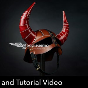 May include: A brown leather helmet with two large red horns. The helmet has a strap and buckle on the chin. The helmet is on a black stand. The text "DIESELPUNK.RO" is visible on the helmet. The text "PDF DOWNLOAD" is visible in the lower right corner of the image.