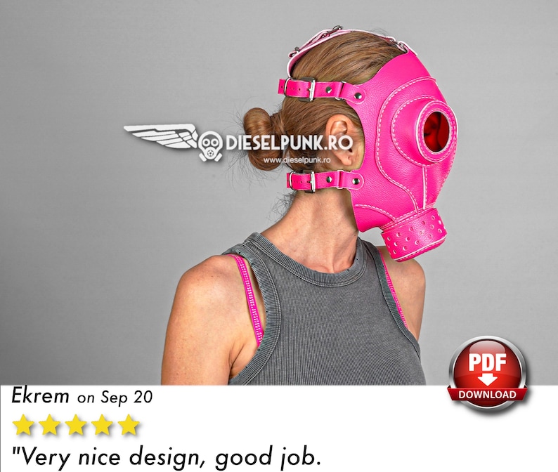 May include: A pink leather gas mask with a white strap and a large round eye hole. The mask has a white stitched design and a white logo on the side that says "DIESELPUNK.RO".