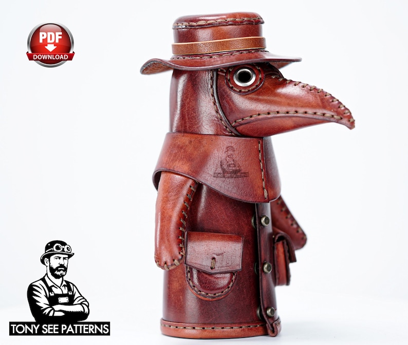 May include: A brown leather plague doctor figurine featuring a wide-brimmed hat, a long beak mask with circular eye lenses, and a coat with small attached pouches. The figure is stitched with visible thread and includes a PDF download icon.