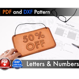 May include: A brown leather sign with the text "50% OFF" in white stitching. The sign is hanging from a string and is surrounded by a white sheet of paper with a grid pattern and letters of the alphabet. The text "Test Page" is visible in the upper right corner of the sheet of paper. The image also includes a pair of glasses, a pair of scissors, and two buttons labeled "PDF Download" and "DXF Laser Files Download".