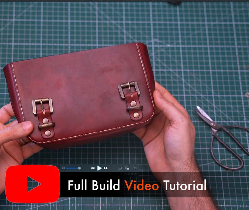 May include: A burgundy leather satchel with brass buckles and white stitching. The bag is rectangular with rounded corners. The text "Full Build Video Tutorial" is displayed on the bottom of the image.