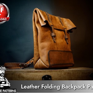 May include: A tan leather roll-top backpack featuring two vertical leather straps with metal buckles on the front. The bag has a rectangular base and a folded top closure. The image includes a PDF download icon and text reading Leather Folding Backpack Patterns.