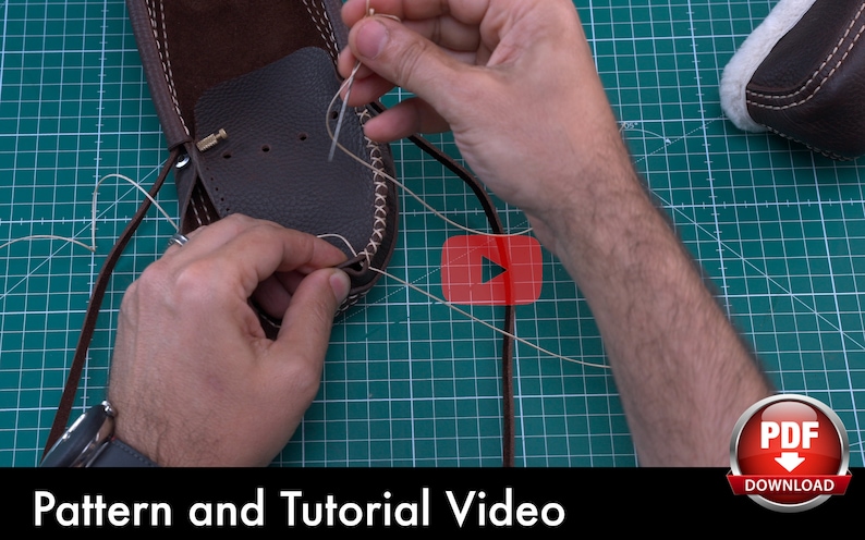 May include: A close-up of someone's hands stitching brown leather together with a needle and thread. The leather is on a green cutting mat. The text "Pattern and Tutorial Video" is at the bottom of the image. A red button with a play symbol is in the top right corner of the image. A red button with the text "PDF Download" is in the bottom right corner of the image.
