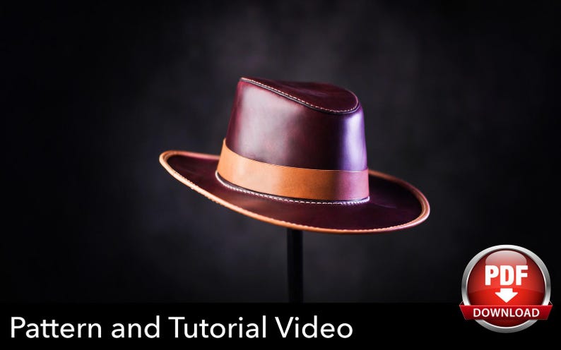 May include: A deep burgundy leather fedora hat featuring a smooth finish, a structured crown, and a wide brim with light tan leather trim. A matching tan leather band encircles the base of the crown. The text PDF DOWNLOAD is visible.