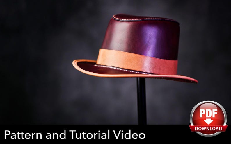 May include: A deep burgundy leather fedora hat featuring a smooth finish, a wide tan leather band around the crown, and a matching tan leather edge trim along the brim. The text Pattern and Tutorial Video is displayed at the bottom.