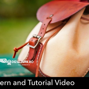 Pode incluir: Um close-up de uma mochila de couro marrom com uma aba de couro marrom claro. A mochila tem um fecho de fivela e um topo com cord&atilde;o. O texto "Pattern and Tutorial Video" est&aacute; na parte inferior da imagem. Um bot&atilde;o vermelho com o texto "PDF DOWNLOAD" est&aacute; no canto inferior direito.