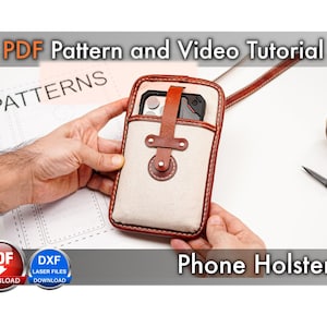 May include: A phone holster featuring a cream-colored canvas body with brown leather trim and a matching leather strap closure. The text "PDF Pattern and Video Tutorial" and "Phone Holster" is visible, along with "PDF DOWNLOAD" and "DXF LASER FILES DOWNLOAD" icons.