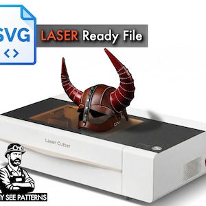 May include: A brown leather Viking helmet with red horns rests on a white laser cutter machine. The image includes the text "SVG Laser Ready File" and a logo for "TONY SEE PATTERNS".