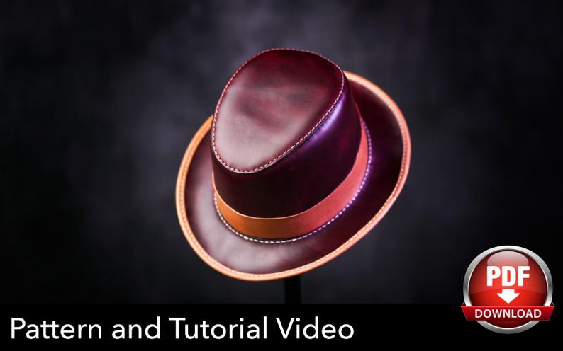 May include: A deep burgundy leather fedora hat featuring a smooth finish, a tan leather hat band, and visible white stitching along the crown and brim edges. The image includes a red circular icon with the white text PDF DOWNLOAD.