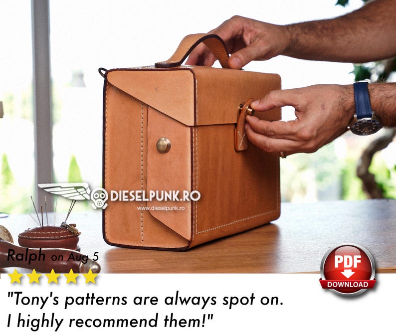 May include: A brown leather briefcase with a metal clasp and a handle. The briefcase is sitting on a wooden table. The text "DIESELPUNK.RO" and "www.dieselpunk.ro" is printed on the briefcase.