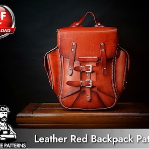 May include: A reddish-brown leather backpack featuring a top flap with two vertical straps, two horizontal buckle closures, and side pockets. The design includes visible white stitching along the edges and metallic hardware. Text reads PDF DOWNLOAD and TONY SEE PATTERNS Leather Red Backpack Patterns.