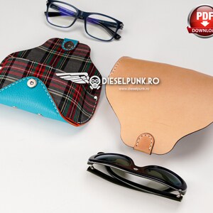 May include: Two different styles of eyeglass cases. One is a brown leather case with a flap. The other is a plaid case with a blue flap. Both cases are closed. A pair of black sunglasses is also pictured.