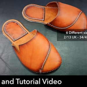 May include: A pair of tan leather slippers featuring a rounded toe, a curved overlapping upper panel, and visible white stitching along the edges. Text on the image reads: 6 Different sizes included 2/13 UK - 34/49 EU - 3/14 US and Pattern and Tutorial Video.