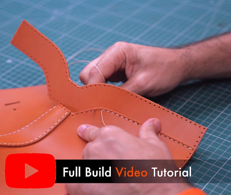 May include: A tan leather piece with pre-punched holes along the edges being hand-stitched with light-colored thread. The leather has a curved flap section and a rectangular body. A red YouTube icon and the text Full Build Video Tutorial appear.