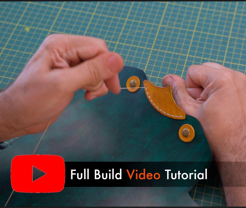 May include: Hands working on a leather project, stitching with thread. The leather is dark green with a tan accent piece. The image includes the text "Full Build Video Tutorial" with a YouTube logo.
