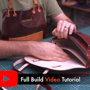 May include: A person is shown working on a red leather satchel. The bag has a flap closure, a zipper, and a shoulder strap. The text "Full Build Video Tutorial" is displayed on the bottom of the image.