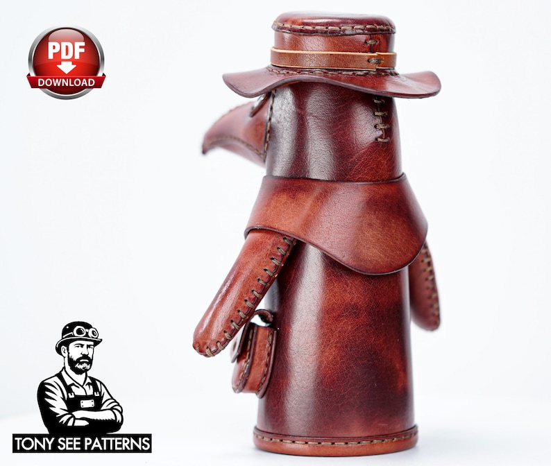 May include: A brown leather plague doctor figurine featuring a wide-brimmed hat, a long beak mask, and a small pouch attached to the side. The figure is constructed with visible stitching along the edges and has a smooth, polished finish.