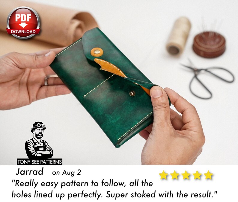 May include: A handcrafted, dark green leather wallet with a contrasting tan interior and a snap closure. The wallet is held open, revealing the interior. The image includes sewing tools and a PDF download icon.