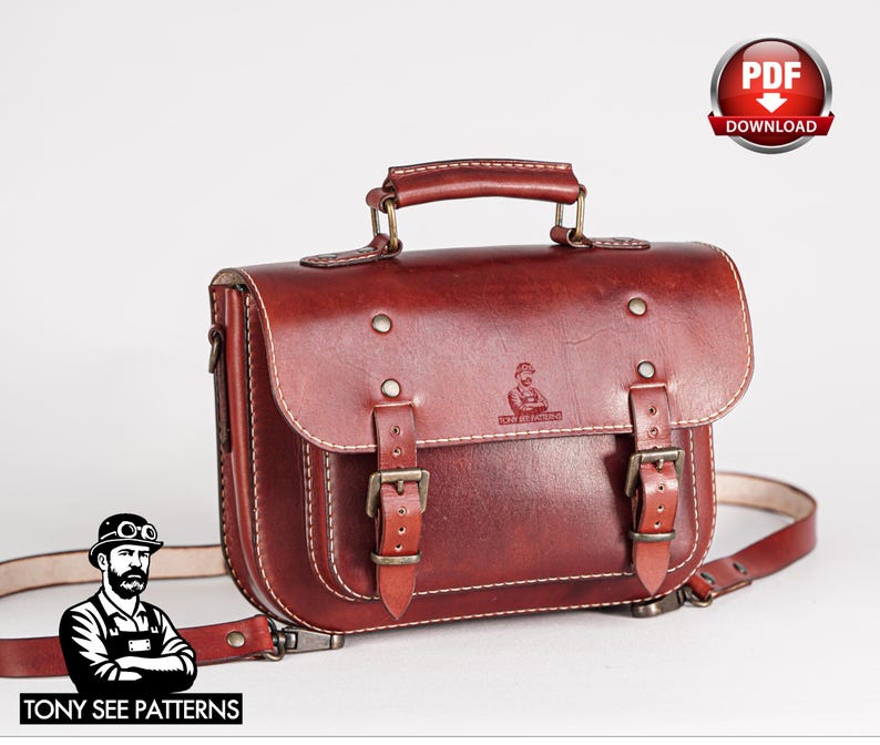 May include: A reddish-brown leather satchel with a top handle and adjustable shoulder strap. The bag features two front buckles and a small logo. The image also includes the text "TONY SEE PATTERNS" and a "PDF DOWNLOAD" graphic.