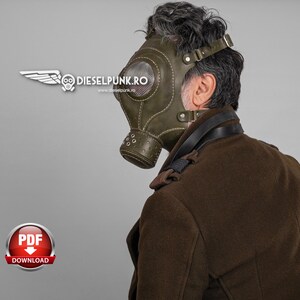 May include: A person wearing a green leather gas mask with a strap around their head and a brown leather jacket. The gas mask has a round window and a metal nose piece. The text "dieselpunk.ro" is visible on the mask.