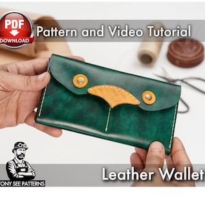 May include: A green leather wallet with a tan accent and gold-colored rivets. The wallet is held in hands, with the text "Pattern and Video Tutorial" and "Leather Wallet" visible. The image also includes a "PDF Download" icon.