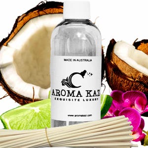 May include: A clear glass bottle with a white cap and label, featuring the text "AROMA KAZ EXQUISITE LUXURY" and "MADE IN AUSTRALIA." The image includes coconut halves, lime slices, pink orchids, and reed diffuser sticks.