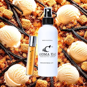 May include: A white spray bottle and a small amber glass roller bottle labeled Aroma Kaz. The white bottle features the text Made in Australia, Aroma Kaz Exquisite Luxury, and the website address. The background displays vanilla ice cream scoops.