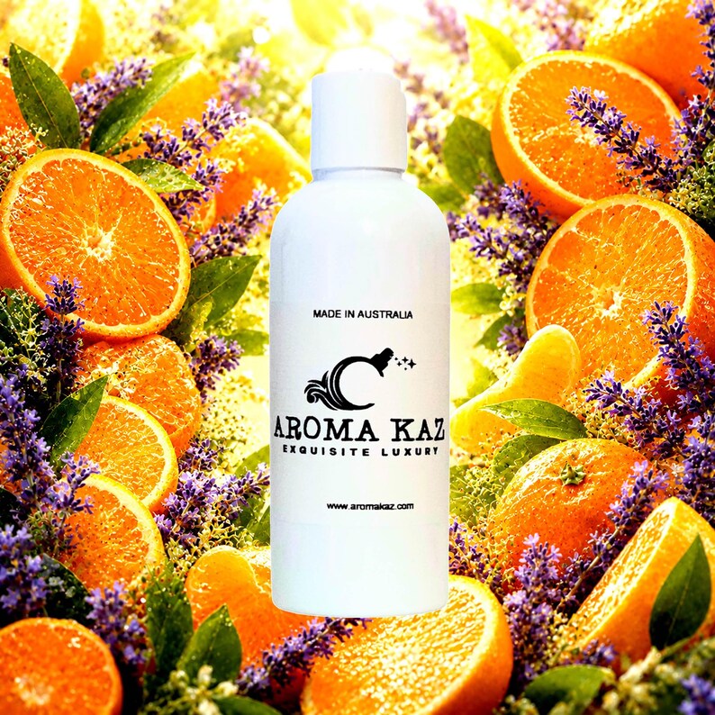 May include: A white bottle with a white cap, featuring the text "AROMA KAZ EXQUISITE LUXURY" and "MADE IN AUSTRALIA." The bottle is surrounded by orange slices, lavender, and green leaves. The website address is www.aromakaz.com.