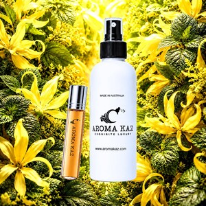 Pode incluir: Um frasco de spray branco e um pequeno frasco de vidro com aplicador roll-on contendo líquido âmbar, ambos com o rótulo Aroma Kaz. O frasco branco apresenta o texto Made in Australia, Aroma Kaz, Exquisite Luxury e www.aromakaz.com. O frasco roll-on exibe o logótipo Aroma Kaz.