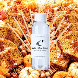 May include: A clear glass reed diffuser bottle with a white cap and a white label featuring the text MADE IN AUSTRALIA, AROMA KAZ, EXQUISITE LUXURY, and www.aromakaz.com, surrounded by several thin wooden diffuser reeds extending outward.