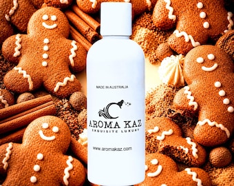 May include: A white cylindrical bottle with a cap, featuring the black text MADE IN AUSTRALIA, AROMA KAZ EXQUISITE LUXURY, and www.aromakaz.com. The bottle is surrounded by brown gingerbread men cookies and cinnamon sticks.