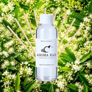 May include: A clear glass reed diffuser bottle with a white cap and a white label featuring the text MADE IN AUSTRALIA, AROMA KAZ, EXQUISITE LUXURY, and www.aromakaz.com, surrounded by several light-colored wooden diffuser reeds.