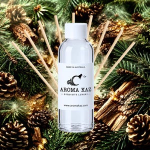 May include: A clear glass bottle with a white cap and a white label featuring the text AROMA KAZ, MADE IN AUSTRALIA, and www.aromakaz.com, surrounded by several thin wooden reed diffuser sticks arranged in a fan shape behind the bottle.