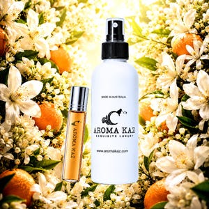 May include: A white spray bottle and a small glass roller bottle containing amber liquid, both labelled Aroma Kaz. The spray bottle features the text Made in Australia, Aroma Kaz, Exquisite Luxury, and the website address on its front surface.