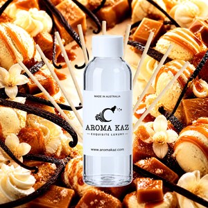 May include: A clear glass bottle with a white cap and a label reading MADE IN AUSTRALIA AROMA KAZ EXQUISITE LUXURY www.aromakaz.com, surrounded by several thin wooden diffuser reeds arranged in a fan shape against a background of vanilla.