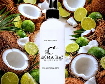 May include: A white spray bottle with a black cap, surrounded by coconuts and lime slices. The bottle has the text "MADE IN AUSTRALIA" and the brand name "AROMA KAZ EXQUISITE LUXURY". The website address www.aromakaz.com is also visible.