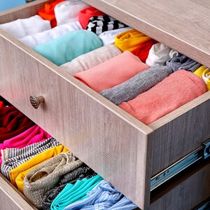 Organised clothes drawer with folded garments showing ideal place for aroma bead air freshener, long-lasting vegan wardrobe and drawer freshener for linens, clothing and small spaces.