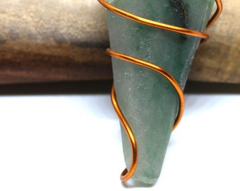 May include: A green stone pendant wrapped in copper wire, hanging from a black cord necklace.
