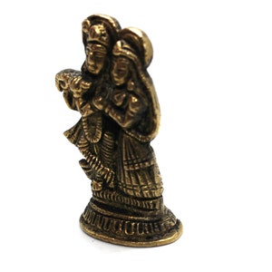 Puede incluir: Una estatua de metal de color dorado de una pareja de pie juntos. La estatua es detallada e intrincada, con la ropa y las joyas de la pareja esculpidas con gran detalle.