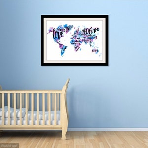May include: A framed watercolor painting of the world map with the word "love" written in different languages. The map is painted in shades of blue and pink.