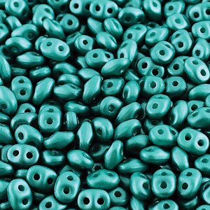 May include: A close-up of a pile of teal green seed beads. The beads are small and have a matte finish.