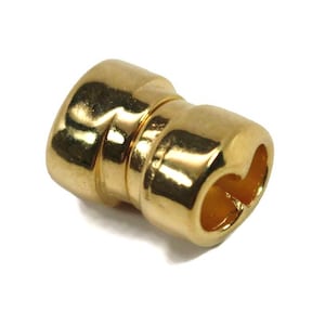 May include: Gold-toned metal connector with a heart-shaped opening. The connector is designed for use with jewelry or other crafts.