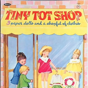 May include: A vintage paper doll book featuring three paper dolls and a shop full of clothes. The cover shows three girls in front of a store with a sign that reads "Tiny Tot Shop 3 paper dolls and a shopful of clothes".