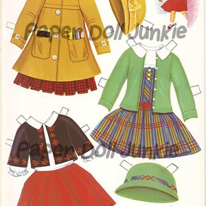 Puede incluir: Un conjunto de mu&ntilde;eca de papel con una ni&ntilde;a que lleva un abrigo amarillo, un c&aacute;rdigan verde y un c&aacute;rdigan marr&oacute;n. El conjunto incluye una falda a cuadros, una falda roja, un sombrero verde y un sombrero marr&oacute;n. El conjunto de mu&ntilde;eca de papel es perfecto para juegos imaginativos.