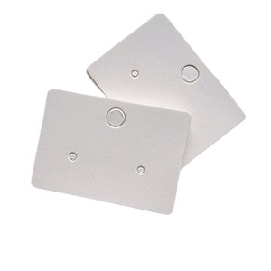 May include: Two white cardboard earring display cards with three holes for earrings. The cards are blank and ready for labelling.