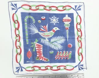 May include: A blue and white Christmas-themed handkerchief with a chain-link border in red and green. The center features festive illustrations of a bird, candy cane, ornaments, and a stocking.
