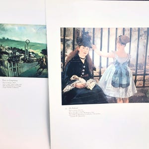 May include: Two framed art prints. The left print depicts a horse race with a green landscape. The right print shows a woman and a girl in front of a fence. The woman is wearing a black coat and hat.