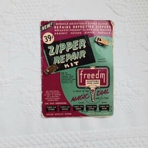 May include: A vintage green and red cardboard package for a zipper repair kit. The package features the text "Zipper Repair Kit" and "Freedm' Adjustable Zipper Slider". The kit includes a "Magic Dial" and is advertised as a "miracle adjustable zipper slider" that "repairs defective zippers".